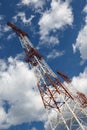 Transmission towers against blue sky and clouds Royalty Free Stock Photo