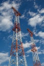 Transmission towers against blue sky and clouds Royalty Free Stock Photo