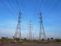 Transmission towers with electricity power line over blue sky and white cloud background Royalty Free Stock Photo