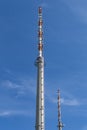 Transmission towers for the transmission of television, radio and mobile in front of a bright blue sky