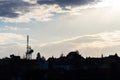 Transmitters and aerials mobile telecommunication tower during beautiful sunset, dramatic cloudy sky with copy space