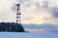 Transmitters and aerials on telecommunication tower, sunset in snowy country Royalty Free Stock Photo