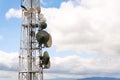 Transmitters and aerials on telecommunication tower with cloudy blue sky Royalty Free Stock Photo