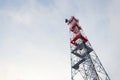 Transmitters and aerials on telecommunication tower, sunset in snowy country Royalty Free Stock Photo