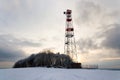 Transmitters and aerials on telecommunication tower, sunset in snowy country Royalty Free Stock Photo