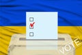 Transparent ballot box for voting with ballot in front Ukraine national flag, Election Process and Democracy, Fair Elections and