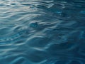 Transparent blue clear water surface texture with ripples, splashes and bubbles. Royalty Free Stock Photo