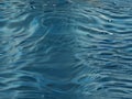 Transparent blue clear water surface texture with ripples, splashes and bubbles. Royalty Free Stock Photo