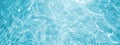 Transparent blue clear water surface texture with ripples, splashes and bubbles. Royalty Free Stock Photo