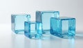 Transparent blue glass cubes on white surface. Illustration presents glossy objects with smooth reflections. Geometric shapes Royalty Free Stock Photo