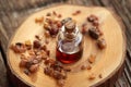 A bottle of essential oil with myrrh resin on a table Royalty Free Stock Photo