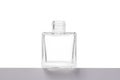 Transparent bottle made of white glass on a gray base, isolate on a white background Royalty Free Stock Photo