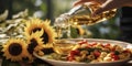 Transparent bottle of oil stands on a wooden table on of a field of sunflowers at background