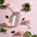 Transparent bottle with serum and rose flowers on pink background. Flat lay, top view. Skincare concept