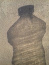 Transparent bottle shadow effect on textured wall , background wallpaper, shaded background Royalty Free Stock Photo