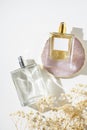 Transparent bottles of perfume and pink marble plate for product presentation and white background. Fragrance Royalty Free Stock Photo