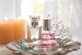 Transparent bottles of perfume on plate Royalty Free Stock Photo