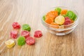 Transparent bowl of multicolor dried pineapple and scattered on