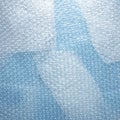 Transparent bubble wrap is laid out on a surface, likely blue or Royalty Free Stock Photo