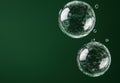 Transparent bubbles on a dark green background Royalty Free Stock Photo