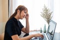 transparent businesswoman dressed in black uses a laptop to work