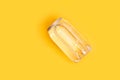 Transparent can of water with bubbles on yellow. Creative idea, new package of clear water in plastic bottle as can Royalty Free Stock Photo