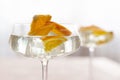 Transparent cocktail with ice cubes in a glass decorated with slices of orange close up Royalty Free Stock Photo