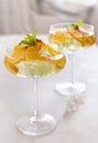 Transparent cocktail with ice cubes in a glass decorated with slices of orange close up Royalty Free Stock Photo