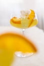 Transparent cocktail with ice cubes in a glass decorated with slices of orange close up Royalty Free Stock Photo