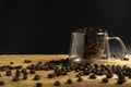 A Cup of coffee beans on old black background