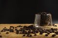 A Cup of coffee beans on old black background