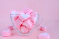 Transparent coffee cup filled with marshmallow. Cute pastel back