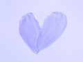 Transparent cosmetic gel heart shape on violet