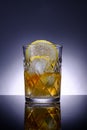 Transparent crystal glass with drink, slice of lemon and ice, advertising photography, selective focus Royalty Free Stock Photo