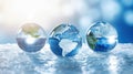 Transparent crystal spheres filled with sunlight on ice surface with blurred background. Glass globes with continents