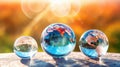 Transparent crystal spheres filled with sunlight on a stone in the forest. Planet Earth and landscapes are reflected the Royalty Free Stock Photo