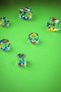 Transparent cubes for casino/transparent cubes for casino are scattered on green cloth. Top view