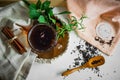 Transparent Cup of tea brewed with adjacent wooden spoons. Cinnamon sticks. Tea time. Tea leafs, Flat Lay