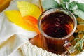 Transparent Cup of tea brewed with adjacent wooden spoons. Cinnamon sticks. Tea time. Tea leafs, Flat Lay. Autumn yellow leaves