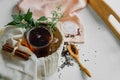 Transparent Cup of tea brewed with adjacent wooden spoons. Cinnamon sticks. Tea time. Tea leafs, Flat Lay