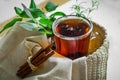 Transparent Cup of tea brewed with adjacent wooden spoons. Cinnamon sticks. Tea time. Tea leafs, Flat Lay