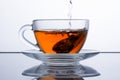 In a transparent cup of tea is poured, black tea is poured.