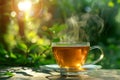 transparent cup of tea with steam rising on a wooden table under the morning sunlight. Blurred green background