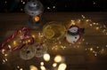 transparent cups with tea and lemon slices, souvenir snowman, cookies, glowing garland lights Royalty Free Stock Photo