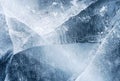 Transparent dark blue ice of frozen Baikal lake with white cracks pattern. Royalty Free Stock Photo