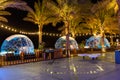 Transparent domed gazebo in style of an igloo for romantic dates of lovers. Night view. Open air restaurant Royalty Free Stock Photo