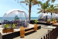 Transparent domed gazebo in style of an igloo for romantic dates of lovers. Open air restaurant Royalty Free Stock Photo