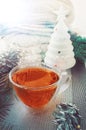 Transparent double bottom glass Cup with hot drink on table with Christmas decor. Warming drink in cold winter Royalty Free Stock Photo