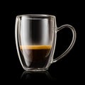 Transparent double wall glass mug with ristretto coffee on black background