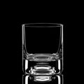 Transparent empty glass of whisky isolated on black background